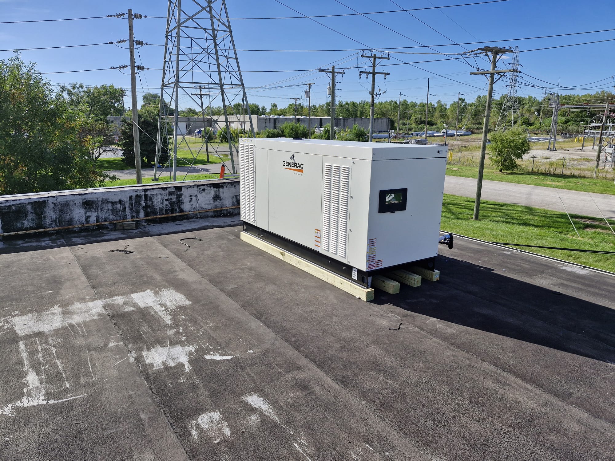 Generac industrial generator installed on rooftop for backup power supply